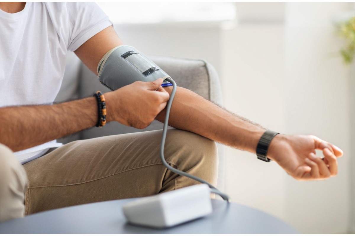 Person checking their blood pressure with at home blood pressure machine